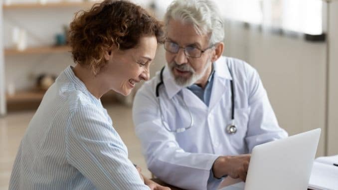 doctor talking to laughing patient