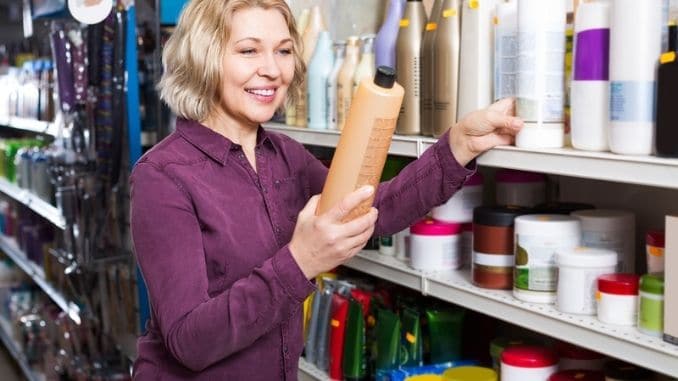 selecting shampoo in store