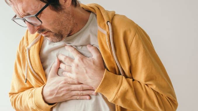 aching man suffering from chest pain